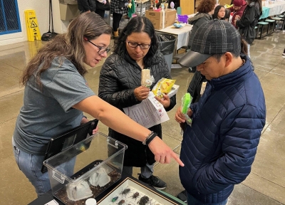 Oregon IPM Educator Paola Sotelo-Cardona (left) talks to participants at a bilingual event in Eugene showcasing the center's work.  Credit: Silvia Rondon